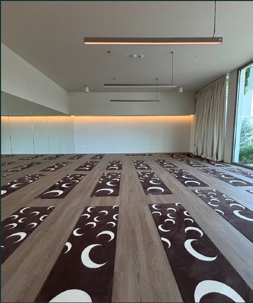 A studio floor laid out with mats before a movement session.